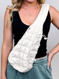 Ivory Quilted Puffer Sling Bag With Adjustable Cross Body Strap & Drawstring Detail