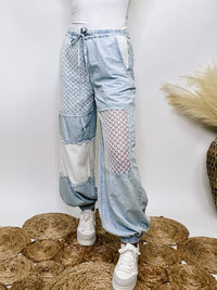 POL Clothing Chambray denim jogger pants with thermal and crochet patches, side pockets, and adjustable waist drawstring.