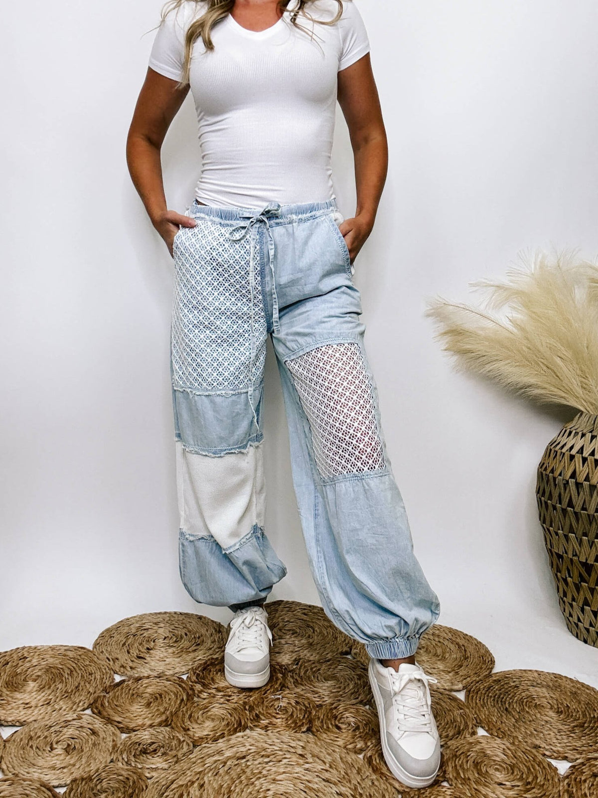 POL Clothing Chambray denim jogger pants with thermal and crochet patches, side pockets, and adjustable waist drawstring.