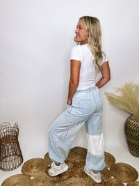 POL Clothing Chambray denim jogger pants with thermal and crochet patches, side pockets, and adjustable waist drawstring.