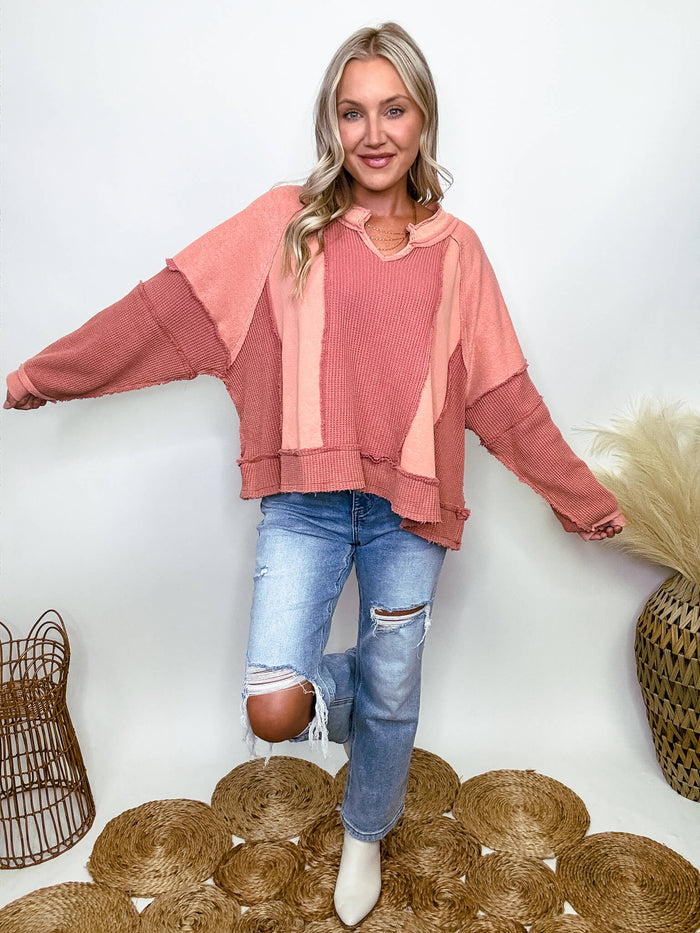 POL Clothing Ginger brick oversized knit top with notched neckline, frayed edges, and exposed seams, made from 100% cotton, ideal for fall fashion