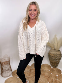 POL Cream chenille cable knit v-neck sweater hoodie by POL, featuring a relaxed fit, cozy design, and versatile styling for casual or dressed-up looks.