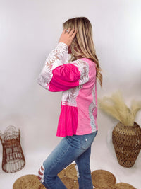 POL Clothing Hot Pink Boho Lace Flare Sleeve V-Neck Top featuring sheer floral lace sleeves, bunched side details, and a relaxed fit, made from a blend of nylon, rayon, and spandex.