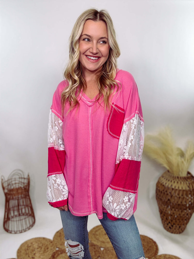 POL Hot Pink and Lace Patch Long Sleeve Boho Top in Hot Pink by POL Clothing with floral lace details, v-neckline, balloon sleeves, and side slits for a chic, stylish look.