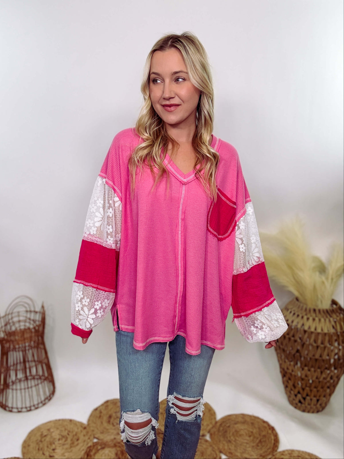 POL Hot Pink and Lace Patch Long Sleeve Boho Top in Hot Pink by POL Clothing with floral lace details, v-neckline, balloon sleeves, and side slits for a chic, stylish look.