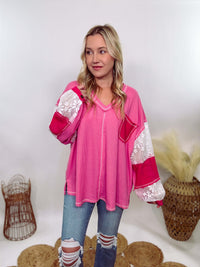 POL Hot Pink and Lace Patch Long Sleeve Boho Top in Hot Pink by POL Clothing with floral lace details, v-neckline, balloon sleeves, and side slits for a chic, stylish look.