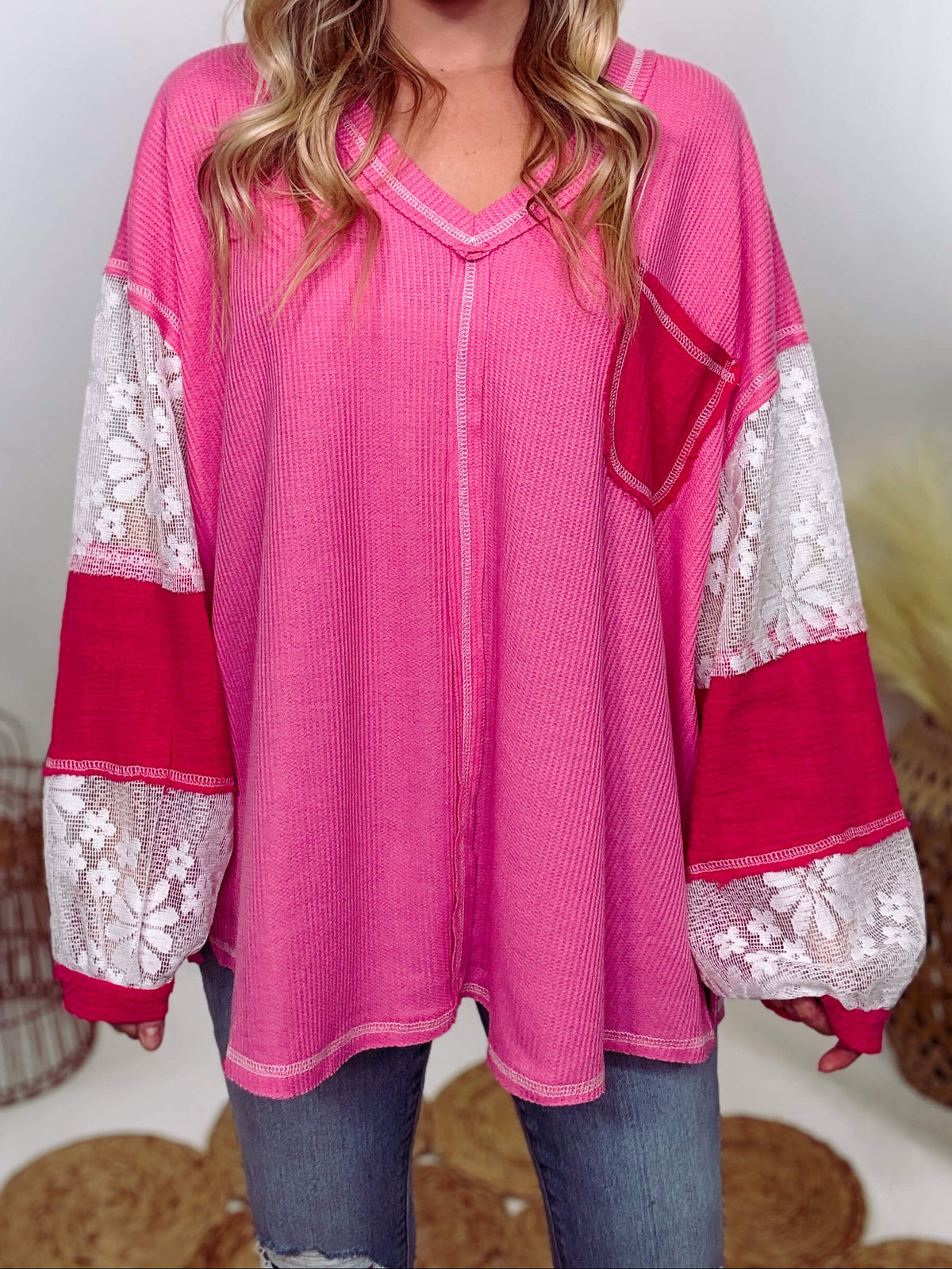 POL Hot Pink and Lace Patch Long Sleeve Boho Top in Hot Pink by POL Clothing with floral lace details, v-neckline, balloon sleeves, and side slits for a chic, stylish look.