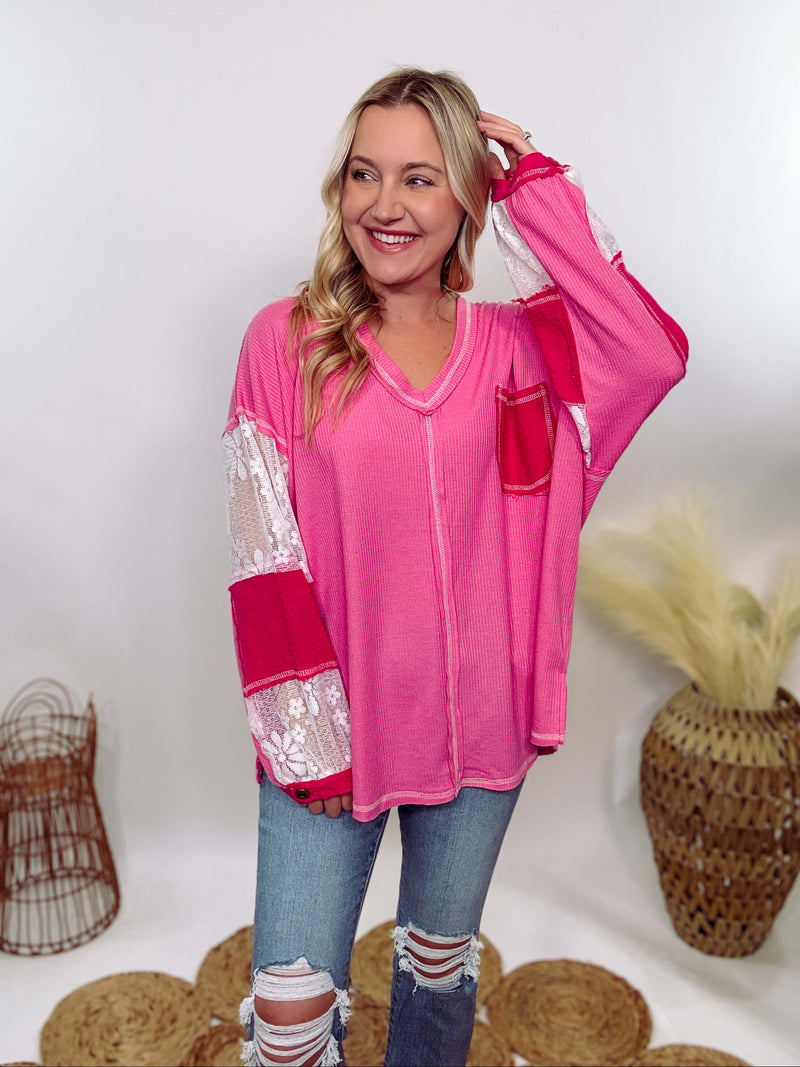 POL Hot Pink and Lace Patch Long Sleeve Boho Top in Hot Pink by POL Clothing with floral lace details, v-neckline, balloon sleeves, and side slits for a chic, stylish look.