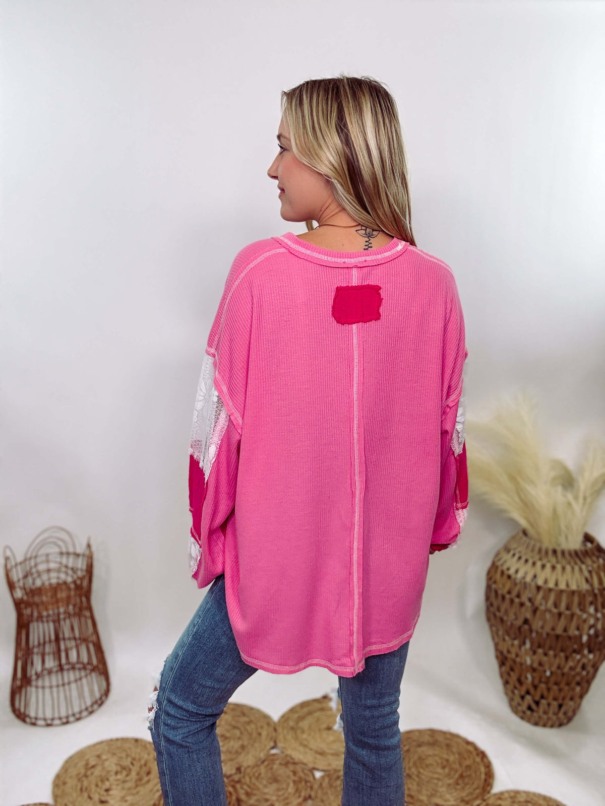 POL Hot Pink and Lace Patch Long Sleeve Boho Top in Hot Pink by POL Clothing with floral lace details, v-neckline, balloon sleeves, and side slits for a chic, stylish look.