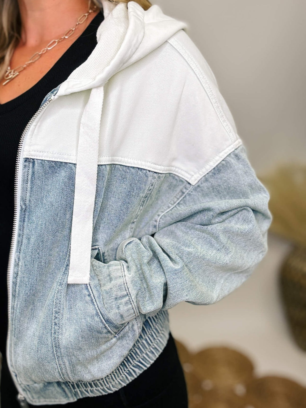 Risen Jeans Light denim bomber jacket with contrast white fabric and hood, side pockets, and elastic waistband.