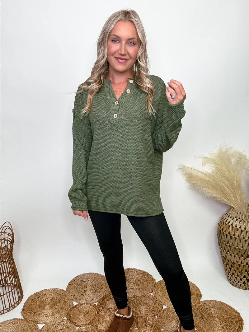 Zenana Olive green midweight sweater with 4-button Henley neckline, side slits, and relaxed fit. Made from 100% acrylic. Model Brooke is 5'4" wearing size small.