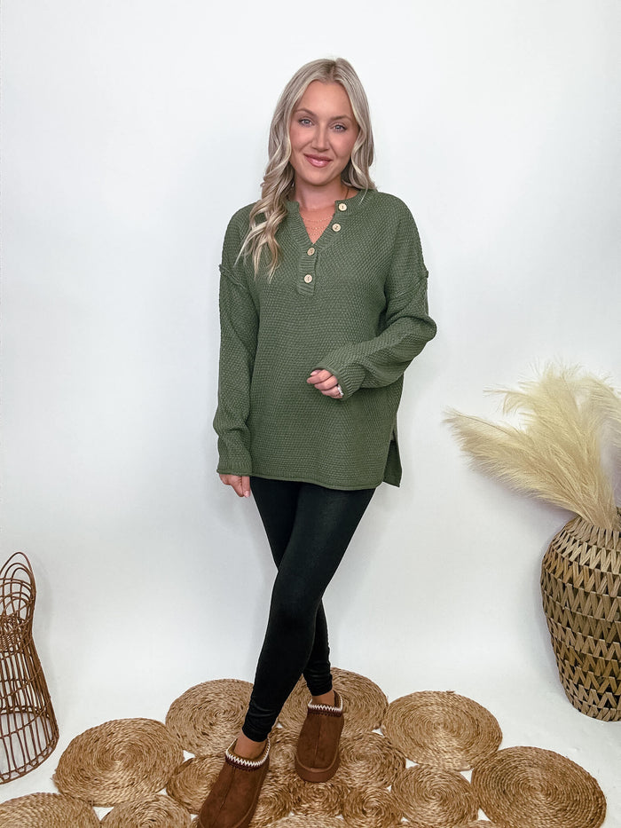 Zenana Olive green midweight sweater with 4-button Henley neckline, side slits, and relaxed fit. Made from 100% acrylic. Model Brooke is 5'4" wearing size small.