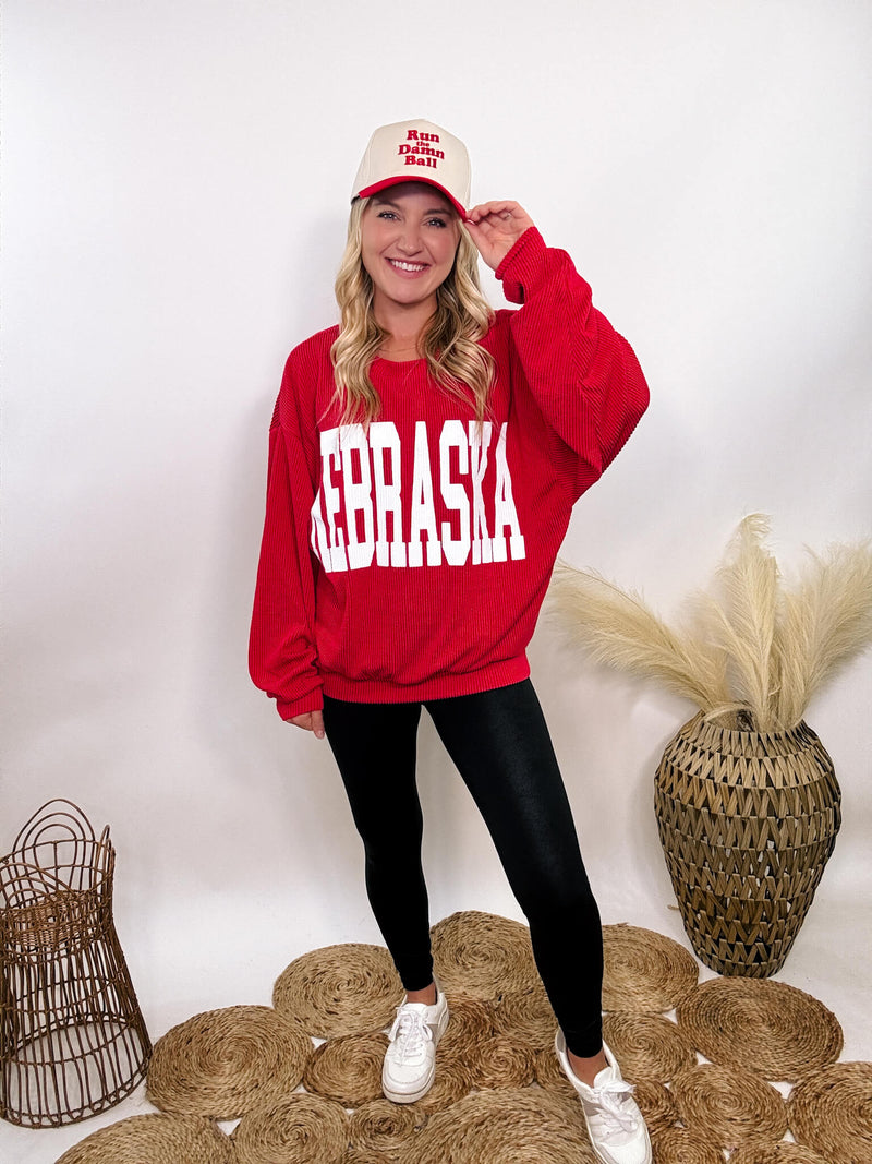 Red Nebraska corded oversized crewneck pullover, perfect for Husker fans, made from 95% polyester and 5% spandex for a stretchy, comfortable fit.