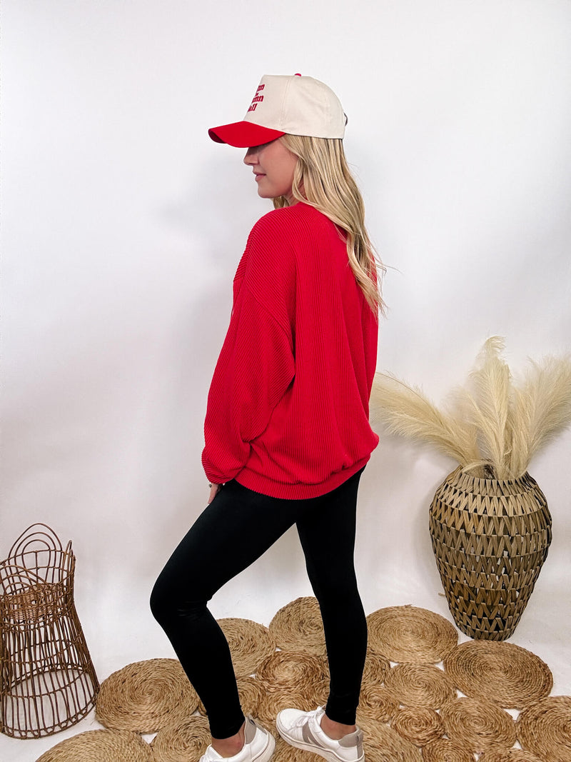 Red Nebraska corded oversized crewneck pullover, perfect for Husker fans, made from 95% polyester and 5% spandex for a stretchy, comfortable fit.