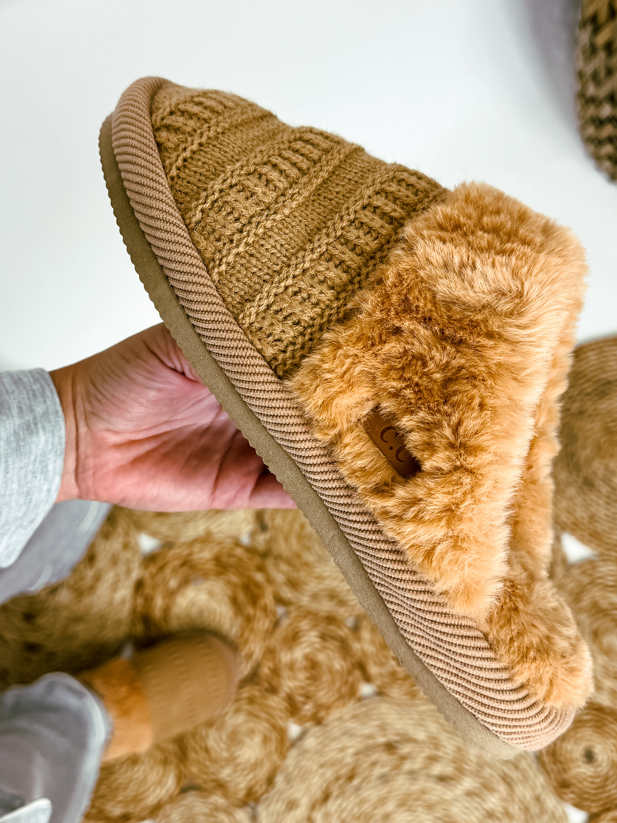 Ribbed pattern knitted slippers with faux fur lining by C.C, available in S/M and M/L sizes, offering cozy comfort.