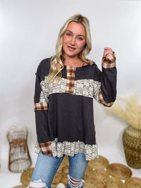 Charcoal thermal Henley by POL with plaid patchwork and lace details. Features Henley button neckline, plaid hoodie, and flowy oversized fit with ruffle hem. Perfect for cozy fall or winter outfits.