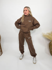 Chocolate brown fleece-lined luxury lounge Bmaes hoodie with embroidered Bmaes Boutique logo, drop shoulders, kangaroo pocket, and ribbed details. Perfect for cozy lounging or pairing with the matching joggers for a stylish, warm set from Bmaes Boutique.