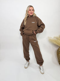 Chocolate brown fleece-lined luxury lounge Bmaes hoodie with embroidered Bmaes Boutique logo, drop shoulders, kangaroo pocket, and ribbed details. Perfect for cozy lounging or pairing with the matching joggers for a stylish, warm set from Bmaes Boutique.