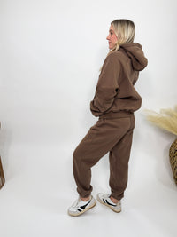 Chocolate brown fleece-lined luxury lounge Bmaes hoodie with embroidered Bmaes Boutique logo, drop shoulders, kangaroo pocket, and ribbed details. Perfect for cozy lounging or pairing with the matching joggers for a stylish, warm set from Bmaes Boutique.