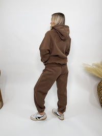 Chocolate brown fleece-lined luxury lounge Bmaes hoodie with embroidered Bmaes Boutique logo, drop shoulders, kangaroo pocket, and ribbed details. Perfect for cozy lounging or pairing with the matching joggers for a stylish, warm set from Bmaes Boutique.