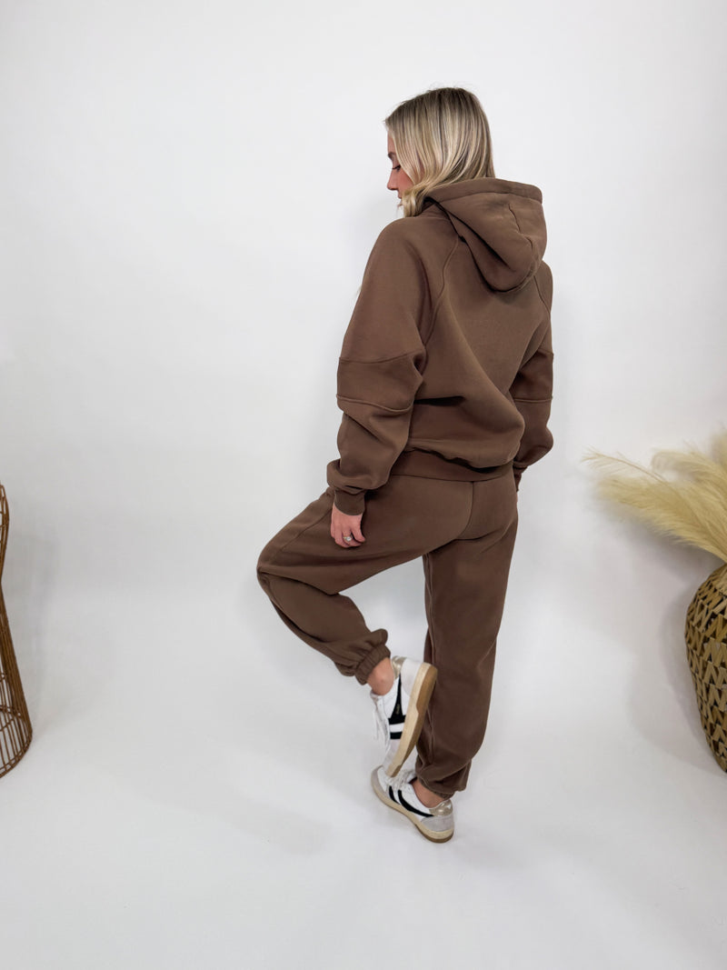 Chocolate brown fleece-lined luxury lounge Bmaes hoodie with embroidered Bmaes Boutique logo, drop shoulders, kangaroo pocket, and ribbed details. Perfect for cozy lounging or pairing with the matching joggers for a stylish, warm set from Bmaes Boutique.