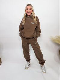 Chocolate brown fleece-lined luxury lounge Bmaes hoodie with embroidered Bmaes Boutique logo, drop shoulders, kangaroo pocket, and ribbed details. Perfect for cozy lounging or pairing with the matching joggers for a stylish, warm set from Bmaes Boutique.