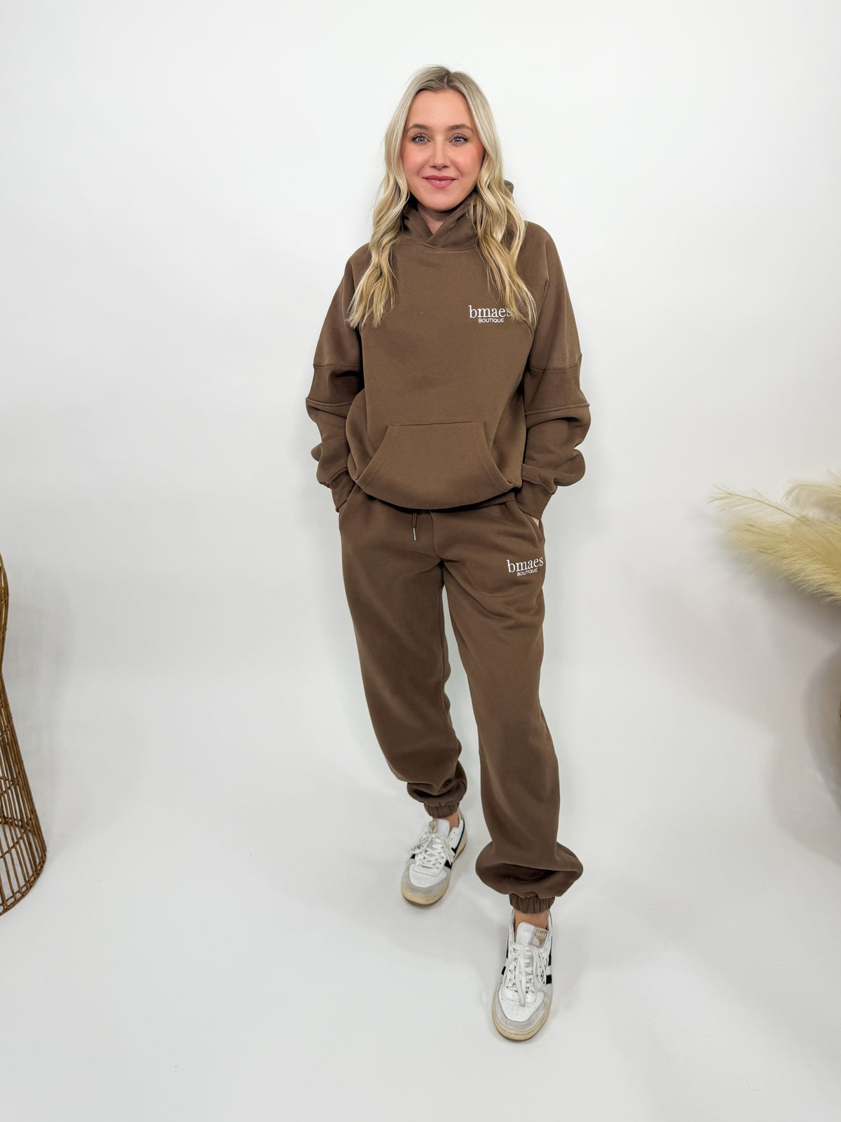 Chocolate brown fleece-lined luxury lounge Bmaes hoodie with embroidered Bmaes Boutique logo, drop shoulders, kangaroo pocket, and ribbed details. Perfect for cozy lounging or pairing with the matching joggers for a stylish, warm set from Bmaes Boutique.