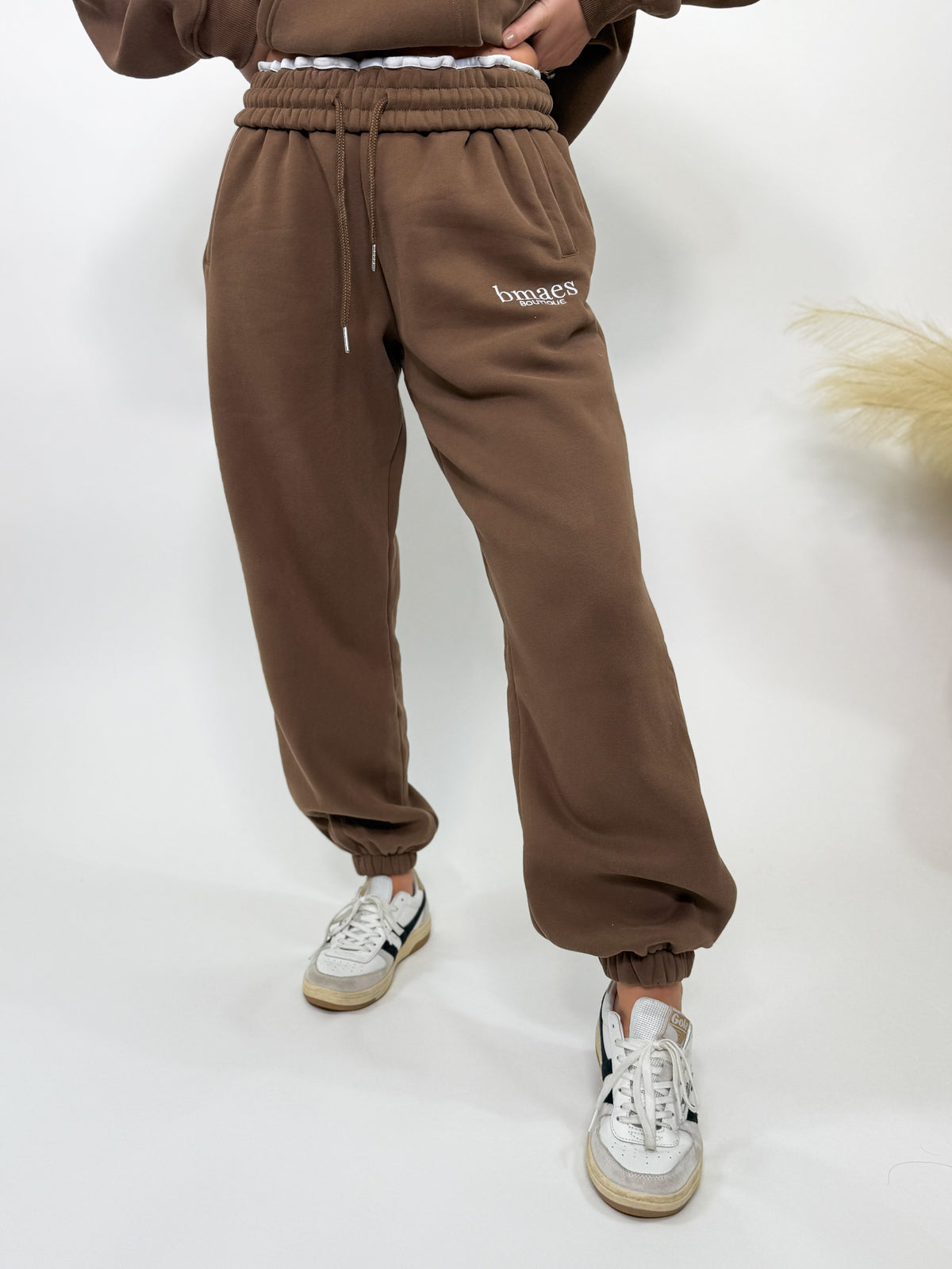 Chocolate brown fleece-lined luxury lounge Bmaes joggers with elastic drawstring waistband, deep pockets, and elastic ankle cuffs. Perfect for lounging or pairing with the matching hoodie for a chic, cozy set from Bmaes Boutique.