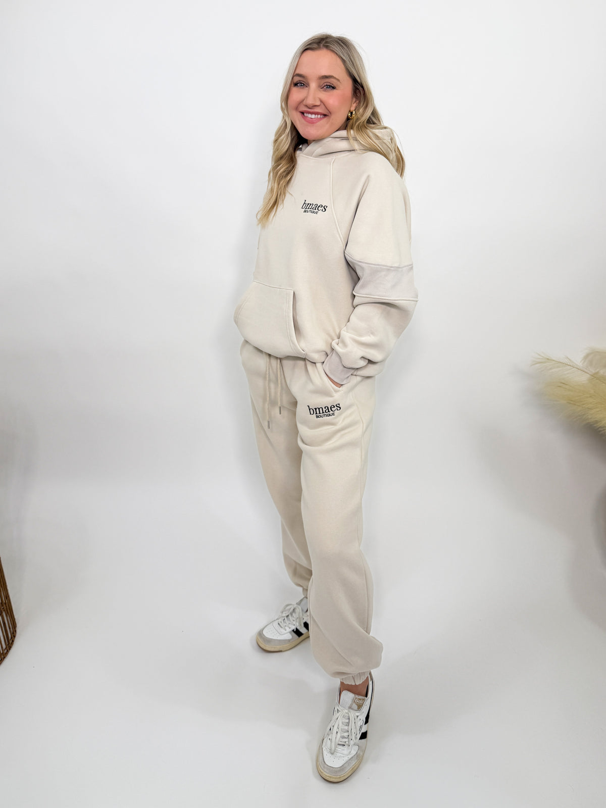 Cream fleece-lined luxury lounge Bmaes hoodie with embroidered Bmaes Boutique logo, drop shoulders, kangaroo pocket, and ribbed details. Perfect for cozy lounging or pairing with the matching joggers for a stylish, warm set from Bmaes Boutique.