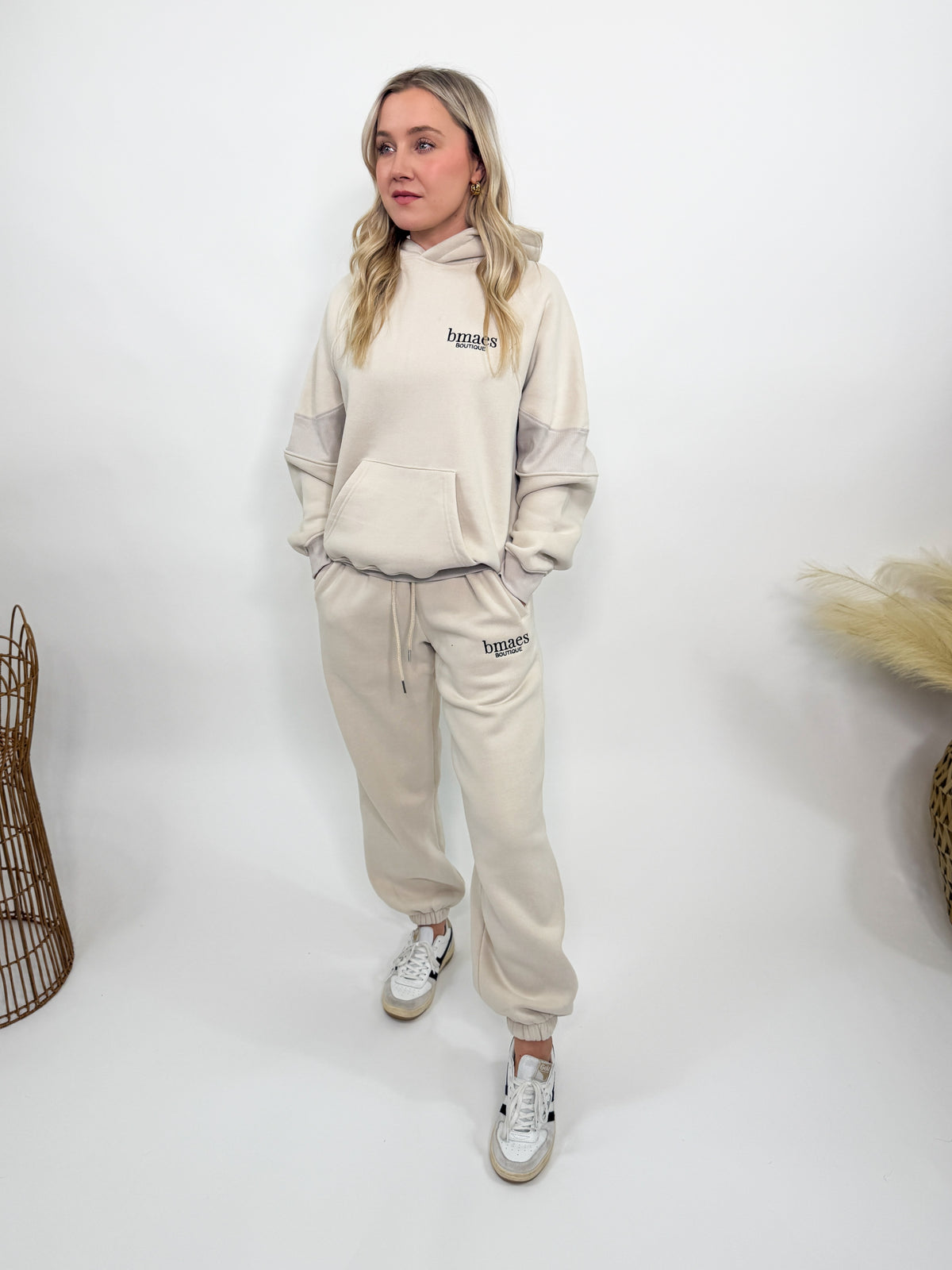 Cream fleece-lined luxury lounge Bmaes hoodie with embroidered Bmaes Boutique logo, drop shoulders, kangaroo pocket, and ribbed details. Perfect for cozy lounging or pairing with the matching joggers for a stylish, warm set from Bmaes Boutique.