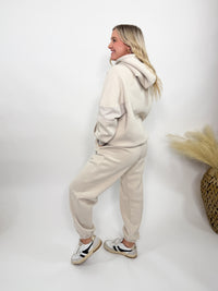 Cream fleece-lined luxury lounge Bmaes hoodie with embroidered Bmaes Boutique logo, drop shoulders, kangaroo pocket, and ribbed details. Perfect for cozy lounging or pairing with the matching joggers for a stylish, warm set from Bmaes Boutique.