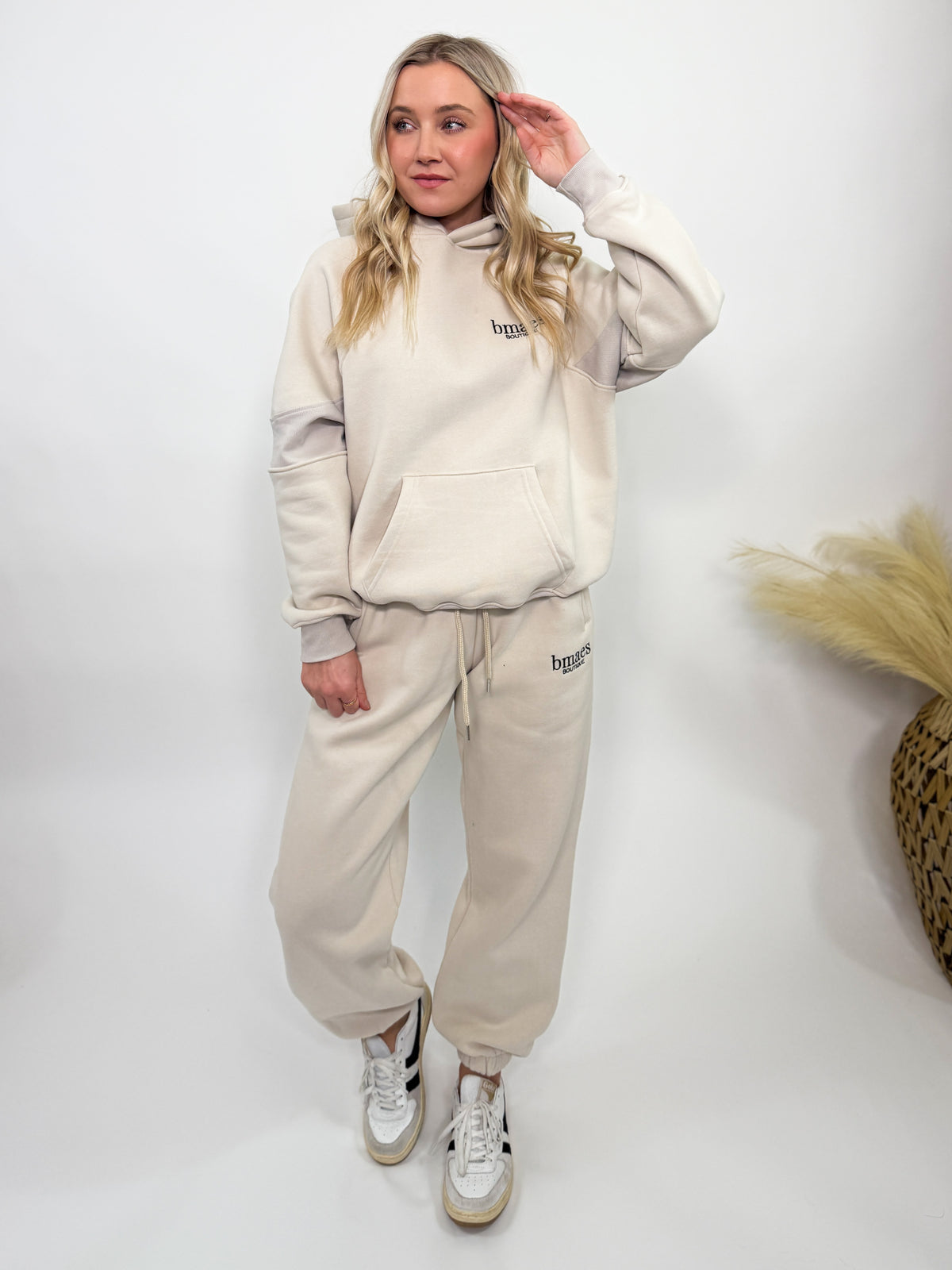 Cream fleece-lined luxury lounge Bmaes hoodie with embroidered Bmaes Boutique logo, drop shoulders, kangaroo pocket, and ribbed details. Perfect for cozy lounging or pairing with the matching joggers for a stylish, warm set from Bmaes Boutique.