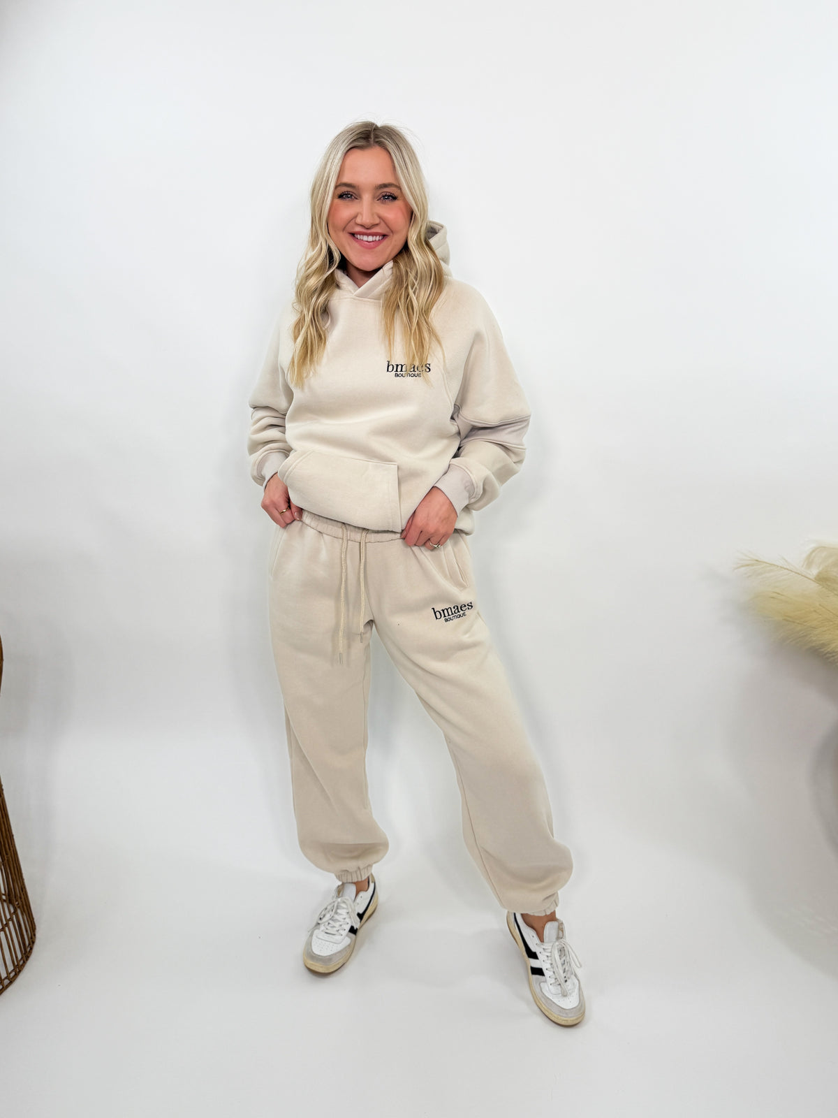 Cream fleece-lined luxury lounge Bmaes hoodie with embroidered Bmaes Boutique logo, drop shoulders, kangaroo pocket, and ribbed details. Perfect for cozy lounging or pairing with the matching joggers for a stylish, warm set from Bmaes Boutique.