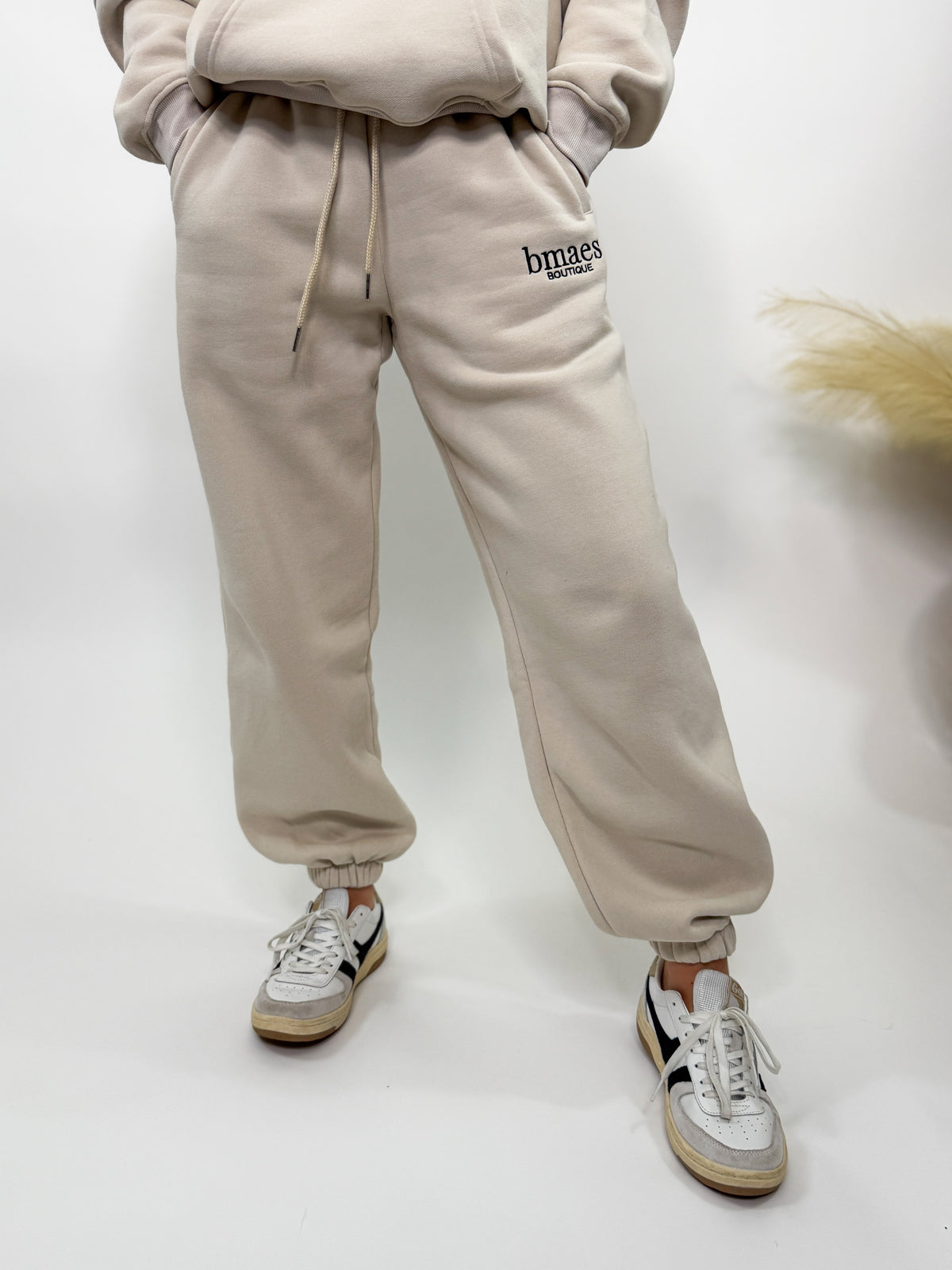 Cream fleece-lined luxury lounge Bmaes joggers with elastic drawstring waistband, deep pockets, and elastic ankle cuffs. Perfect for lounging or pairing with the matching hoodie for a chic, cozy set from Bmaes Boutique.