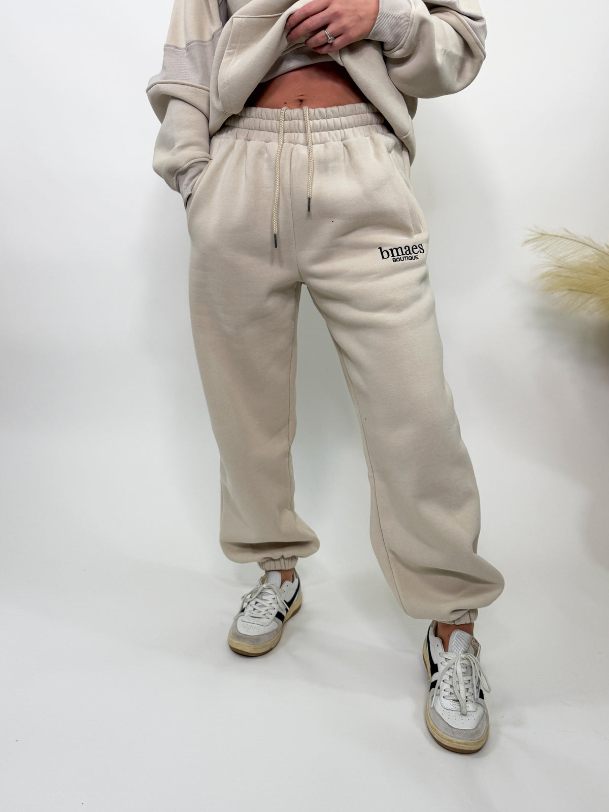 Cream fleece-lined luxury lounge Bmaes joggers with elastic drawstring waistband, deep pockets, and elastic ankle cuffs. Perfect for lounging or pairing with the matching hoodie for a chic, cozy set from Bmaes Boutique.