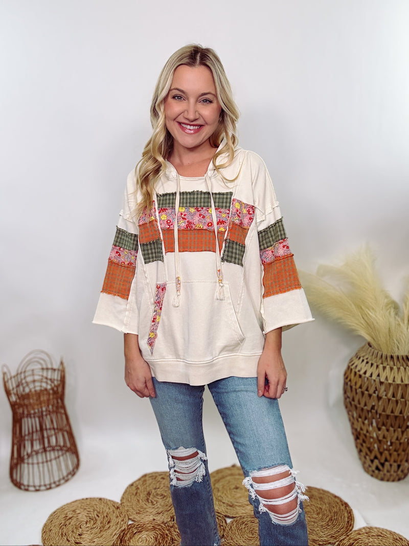 Easel Patchwork Hoodie with mixed plaid and floral patterns, 3/4 wide sleeves, raw hem, side slits, and a relaxed loose fit, made with 85% cotton, 15% polyester, and 5% spandex.