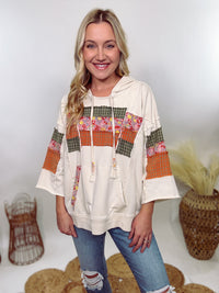 Easel Patchwork Hoodie with mixed plaid and floral patterns, 3/4 wide sleeves, raw hem, side slits, and a relaxed loose fit, made with 85% cotton, 15% polyester, and 5% spandex.