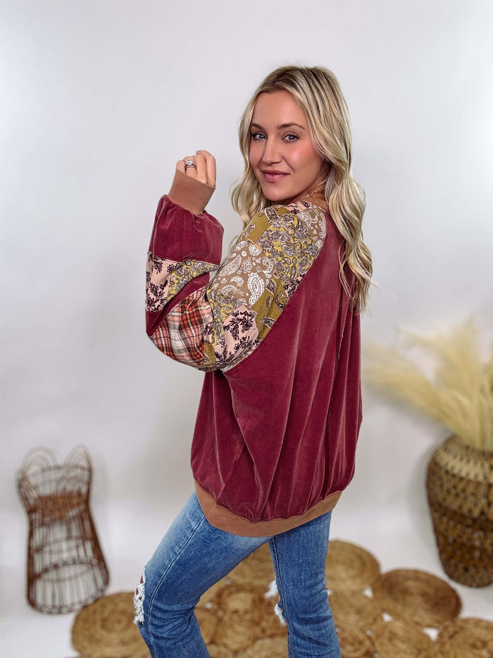 Easel Washed cherry boho long sleeve pullover with patchwork plaid and vintage paisley print details. Exposed seam detail on the back, soft material, and an oversized fit for a relaxed, bohemian winter style.