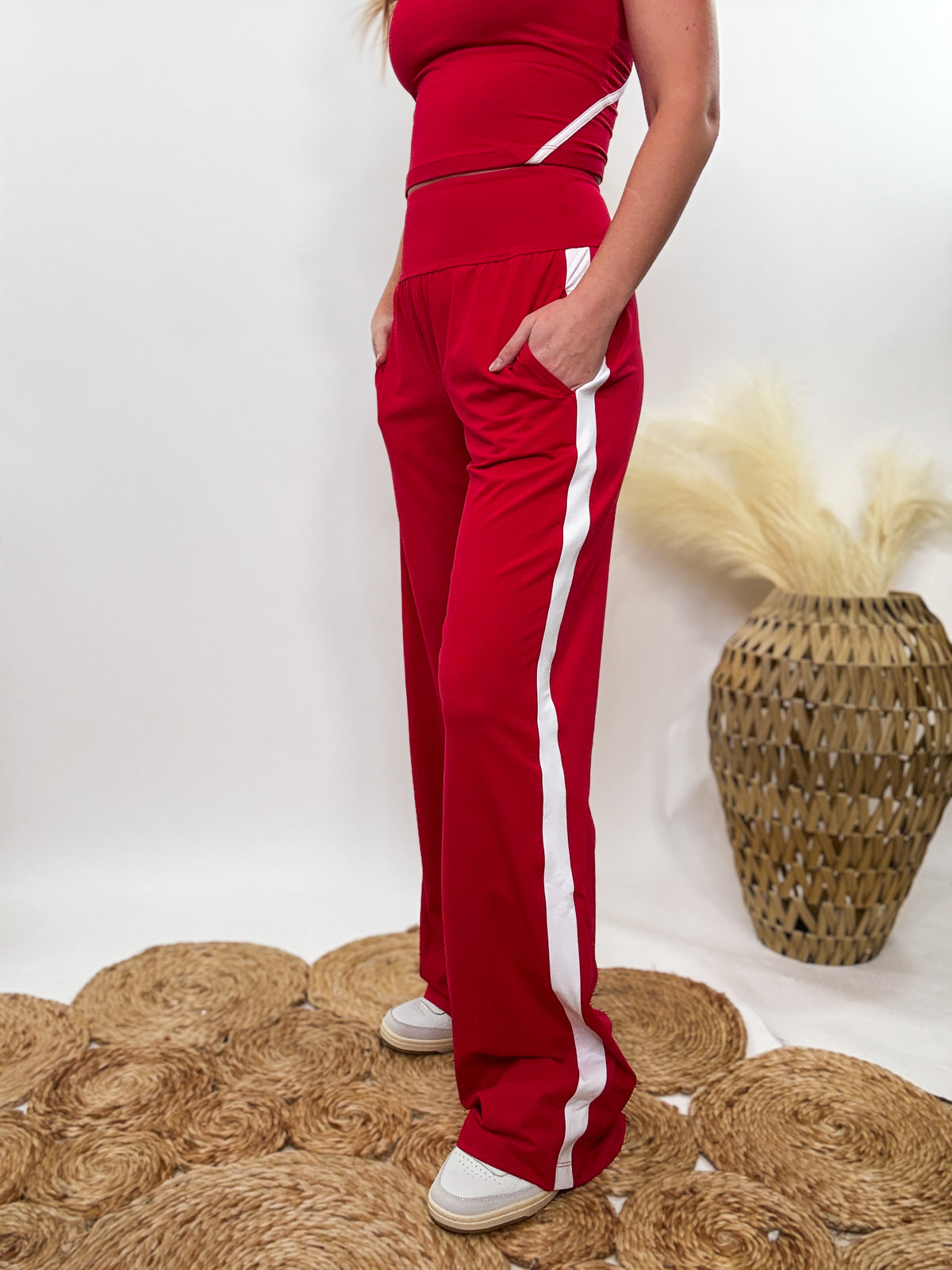 Red & White Sporty High-Waisted Straight-Leg Pants with contrast white piping detail. Relaxed fit, 4-way stretch fabric, and side pockets. Part of a matching lounge set, perfect for workouts, lounging, and casual wear.