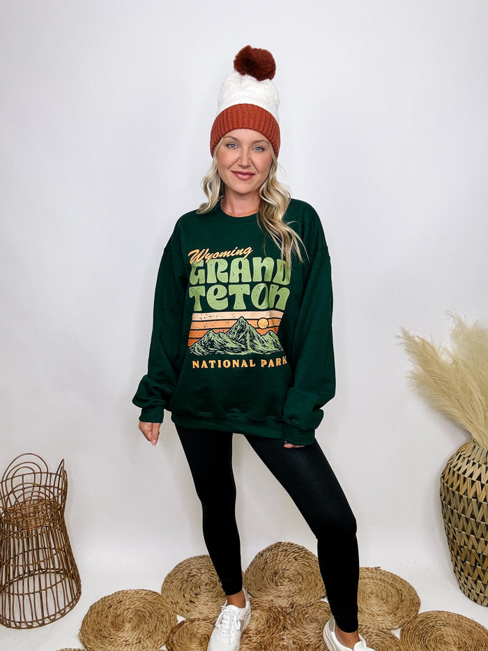 Golden Rose Co Retro Wyoming Grand Teton National Park oversized graphic sweatshirt in forest green, featuring a fleece-lined interior and a vintage-inspired mountain graphic.