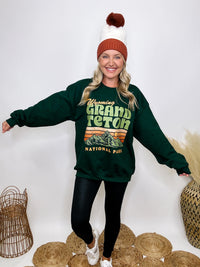 Golden Rose Co Retro Wyoming Grand Teton National Park oversized graphic sweatshirt in forest green, featuring a fleece-lined interior and a vintage-inspired mountain graphic.