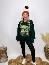 Golden Rose Co Retro Wyoming Grand Teton National Park oversized graphic sweatshirt in forest green, featuring a fleece-lined interior and a vintage-inspired mountain graphic.