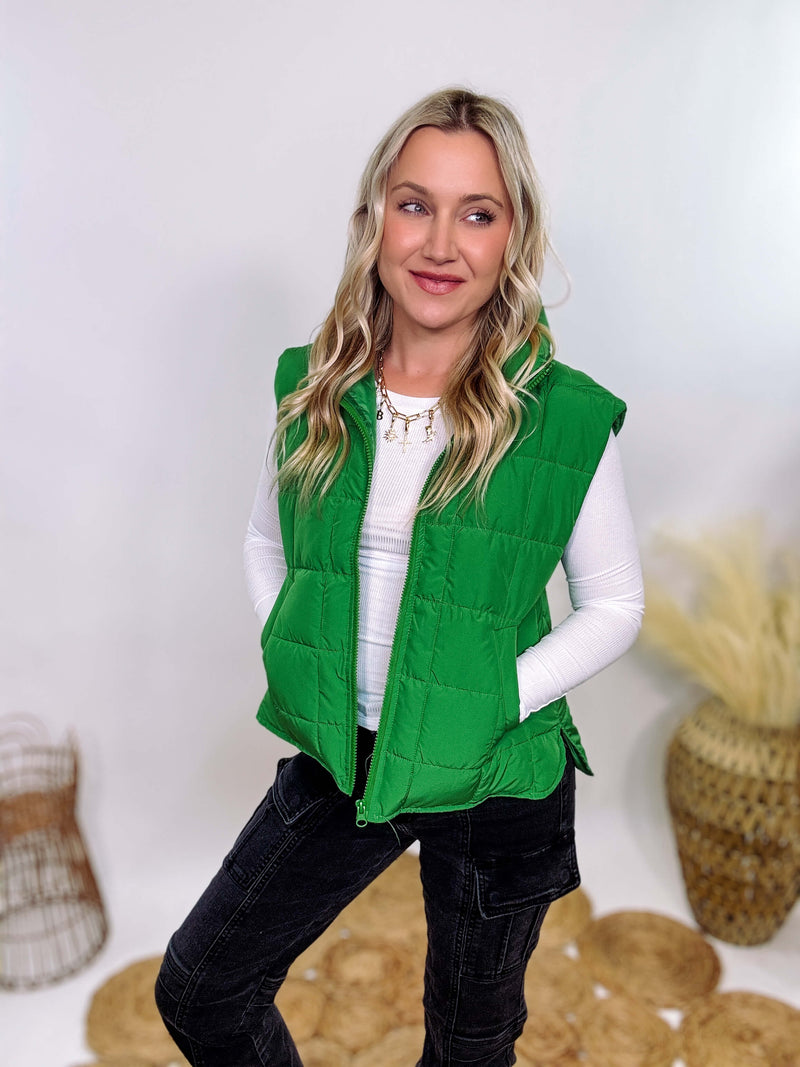 Vibrant green padded puffer vest with side slits and a zip-up front, perfect for layering and staying warm.