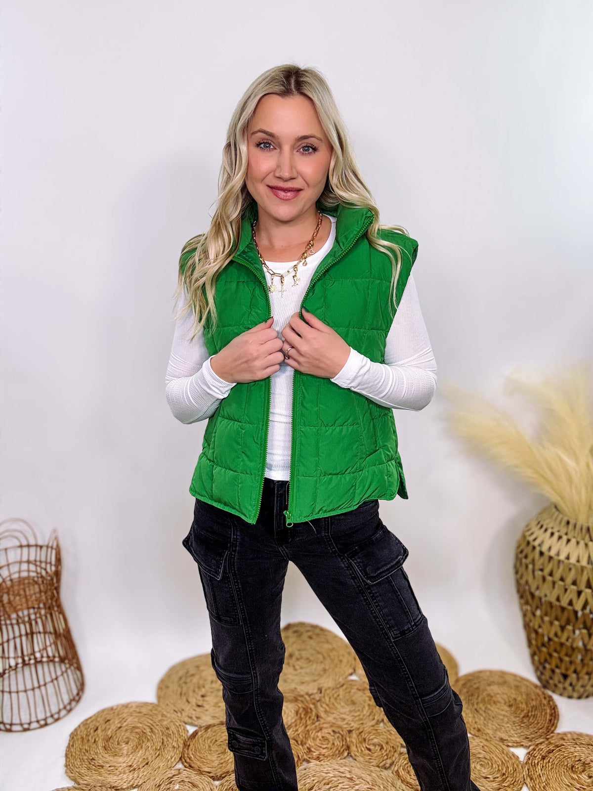 Vibrant green padded puffer vest with side slits and a zip-up front, perfect for layering and staying warm.