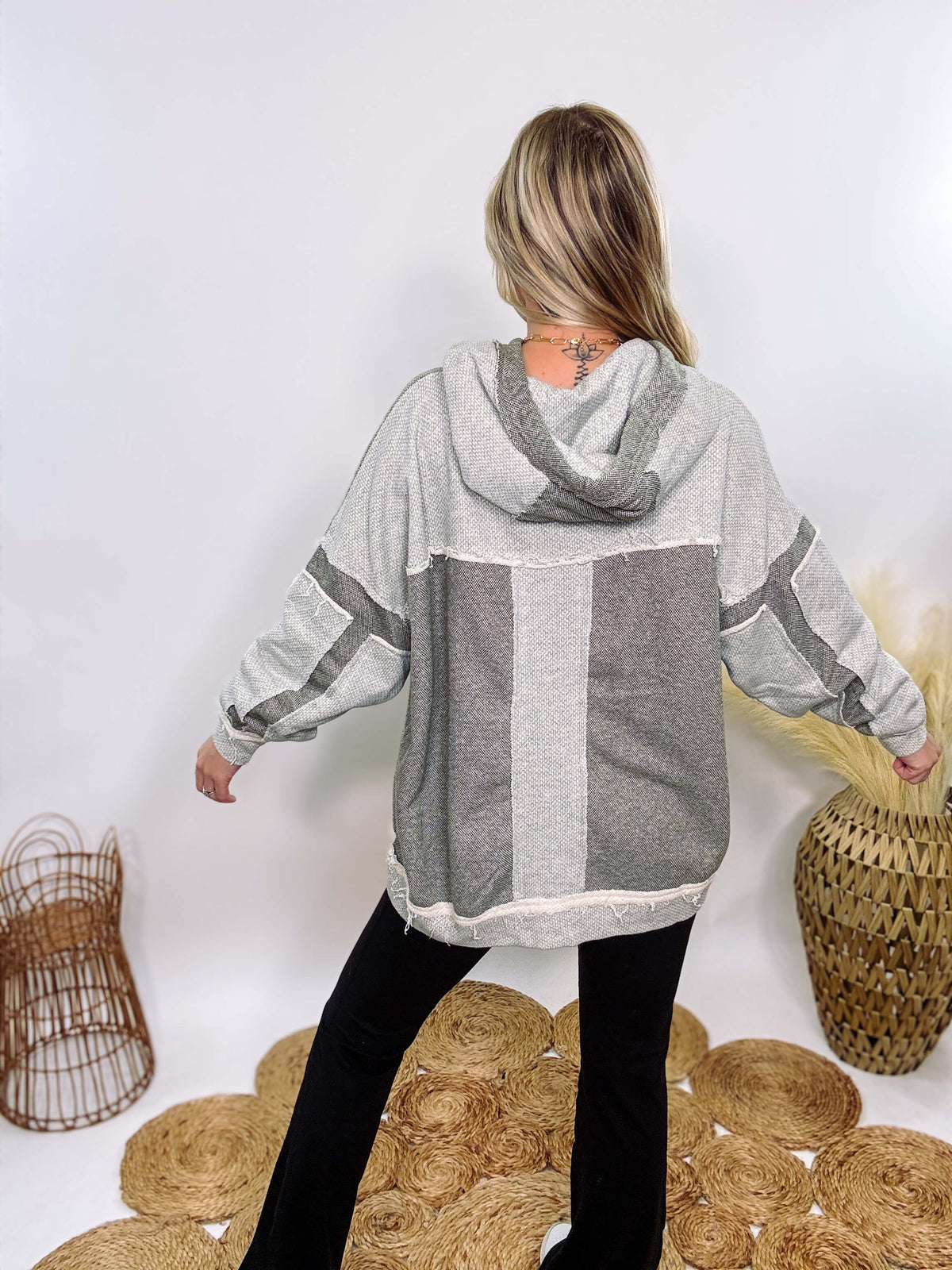 Grey olive patchwork oversized hoodie by Oli & Hali with contrast patchwork sleeves, drawstring hood, front kangaroo pocket, and exposed raw hems. Cozy and stylish design for everyday wear.