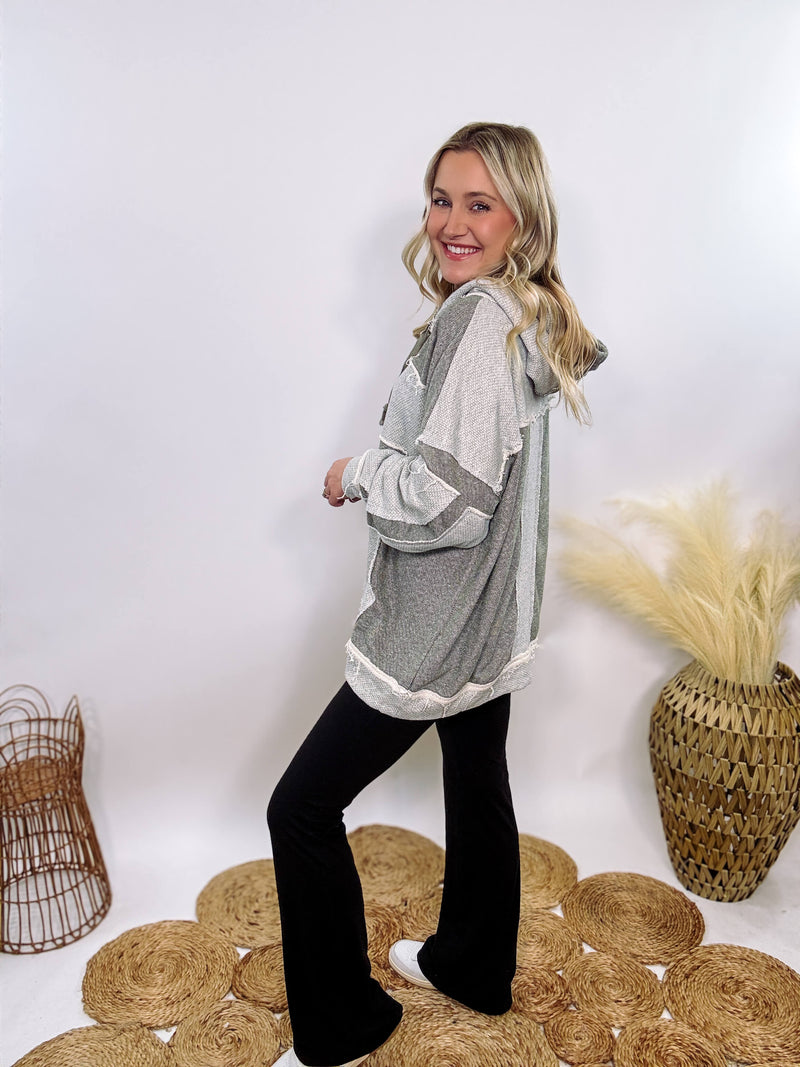 Grey olive patchwork oversized hoodie by Oli & Hali with contrast patchwork sleeves, drawstring hood, front kangaroo pocket, and exposed raw hems. Cozy and stylish design for everyday wear.