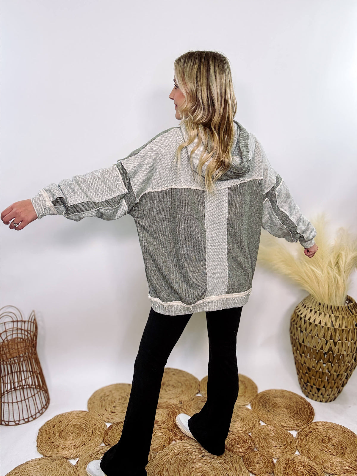 Grey olive patchwork oversized hoodie by Oli & Hali with contrast patchwork sleeves, drawstring hood, front kangaroo pocket, and exposed raw hems. Cozy and stylish design for everyday wear.