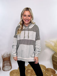 Grey olive patchwork oversized hoodie by Oli & Hali with contrast patchwork sleeves, drawstring hood, front kangaroo pocket, and exposed raw hems. Cozy and stylish design for everyday wear.