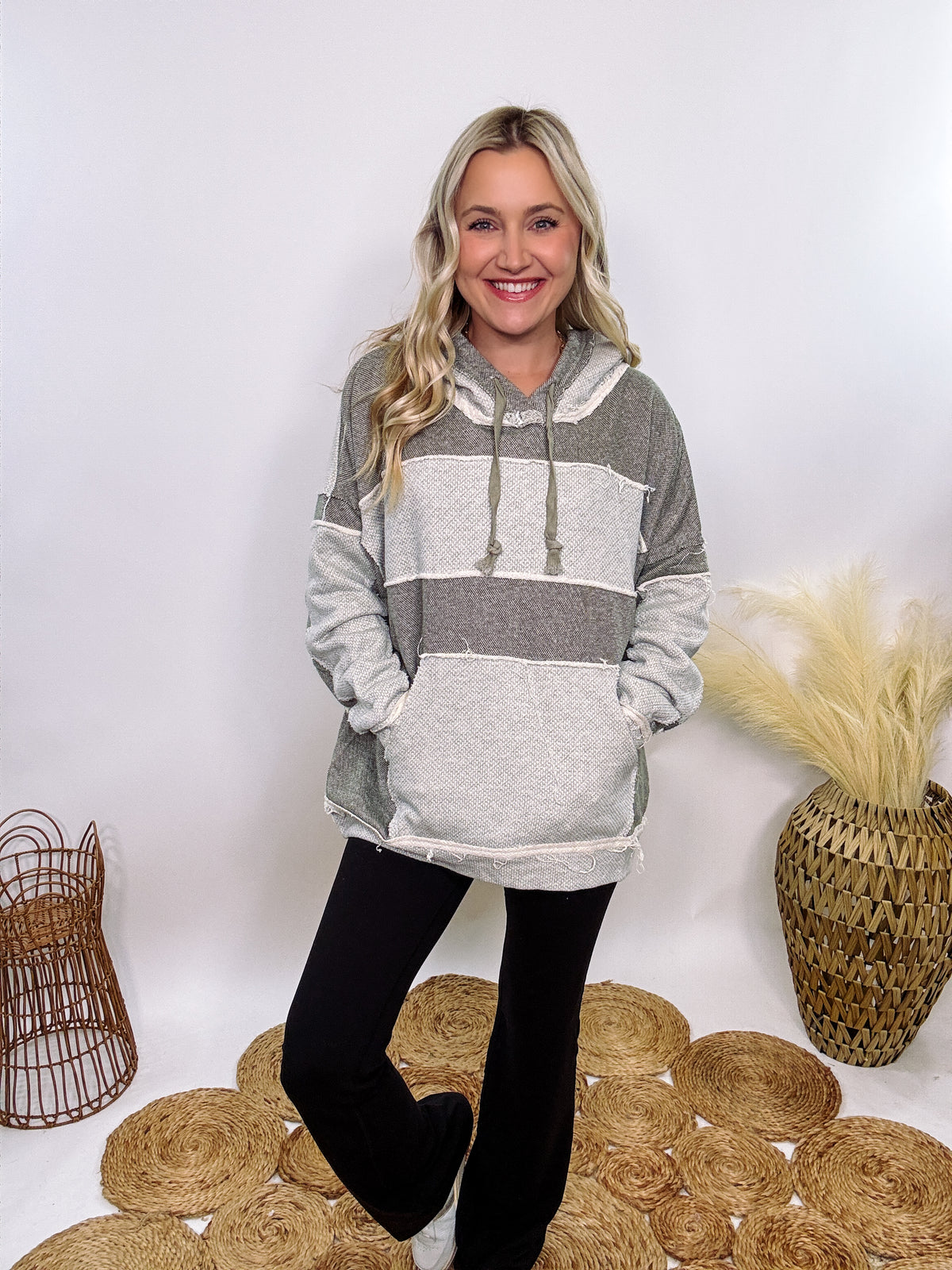 Grey olive patchwork oversized hoodie by Oli & Hali with contrast patchwork sleeves, drawstring hood, front kangaroo pocket, and exposed raw hems. Cozy and stylish design for everyday wear.