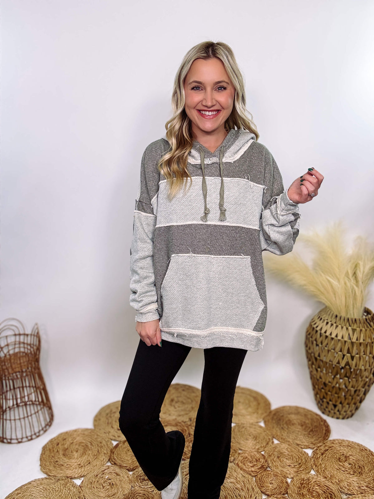 Grey olive patchwork oversized hoodie by Oli & Hali with contrast patchwork sleeves, drawstring hood, front kangaroo pocket, and exposed raw hems. Cozy and stylish design for everyday wear.